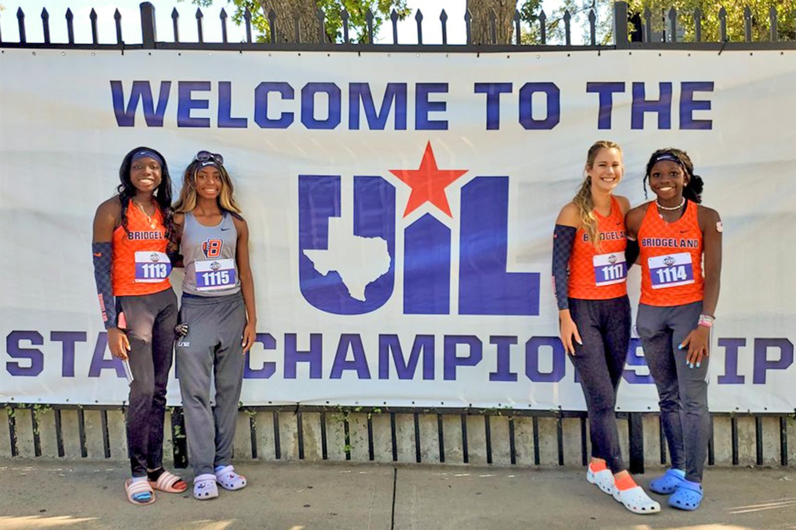 The Bridgeland High School girls’ 4x400-meter team pose before the running session at the state meet.